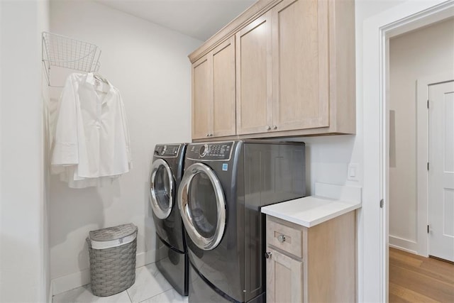 209 Pont Neuf Ct, Edmond, OK 73034 - laundry area featuring cabinet space, washer and clothes dryer, and light wood-style floors