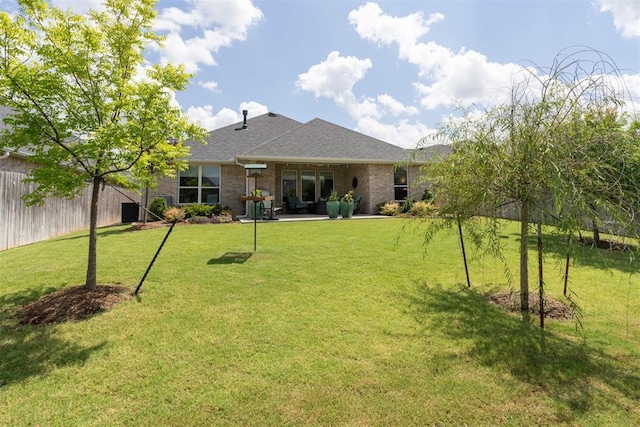 209 Pont Neuf Ct, Edmond, OK 73034 - back of property with brick siding, a shingled roof, and a patio