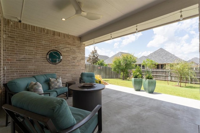 209 Pont Neuf Ct, Edmond, OK 73034 - fenced backyard featuring a patio area, a ceiling fan, and an outdoor living space with a fire pit
