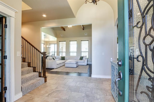 10812 Wild Horse Creek Dr, Yukon, OK 73099 - foyer entrance featuring stairs, arched walkways, vaulted ceiling, a chandelier, and light tile patterned floors