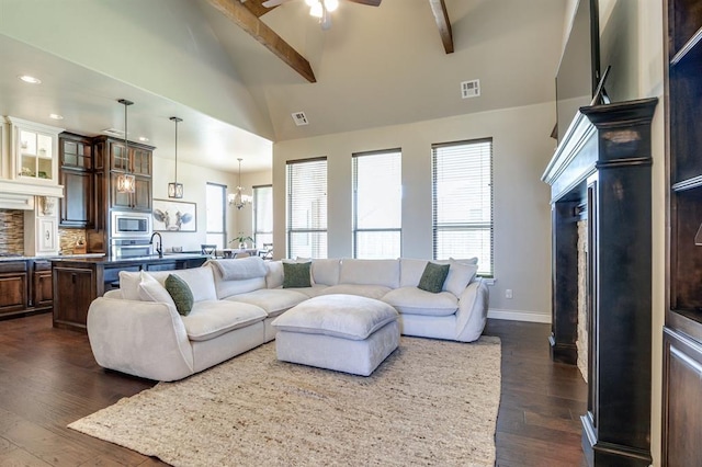 10812 Wild Horse Creek Dr, Yukon, OK 73099 - living room featuring a fireplace, dark wood finished floors, a ceiling fan, beamed ceiling, and recessed lighting