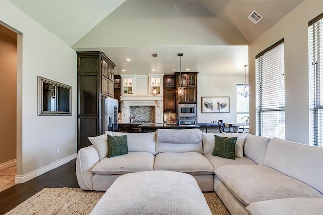 10812 Wild Horse Creek Dr, Yukon, OK 73099 - living room featuring vaulted ceiling, wood finished floors, and recessed lighting