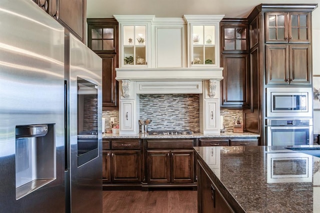 10812 Wild Horse Creek Dr, Yukon, OK 73099 - kitchen featuring appliances with stainless steel finishes, dark brown cabinets, and dark stone counters