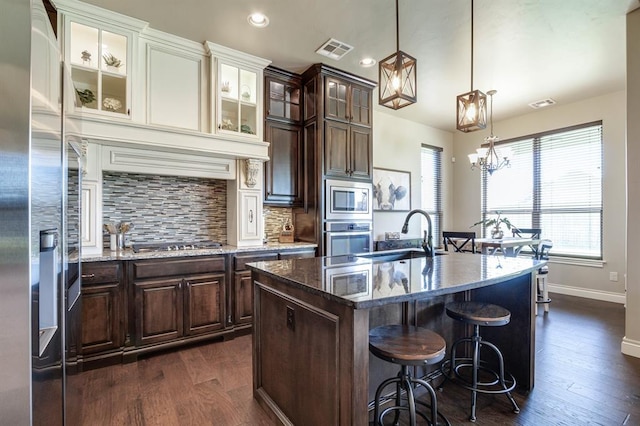 10812 Wild Horse Creek Dr, Yukon, OK 73099 - kitchen with appliances with stainless steel finishes, plenty of natural light, dark wood-style flooring, and recessed lighting