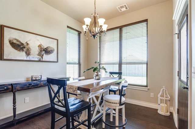 10812 Wild Horse Creek Dr, Yukon, OK 73099 - dining room featuring dark wood finished floors and a chandelier