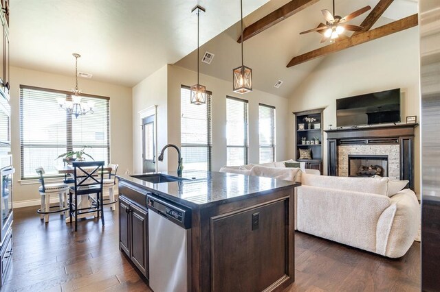 10812 Wild Horse Creek Dr, Yukon, OK 73099 - kitchen featuring dishwasher, dark wood-style flooring, a chandelier, dark brown cabinetry, and a stone fireplace