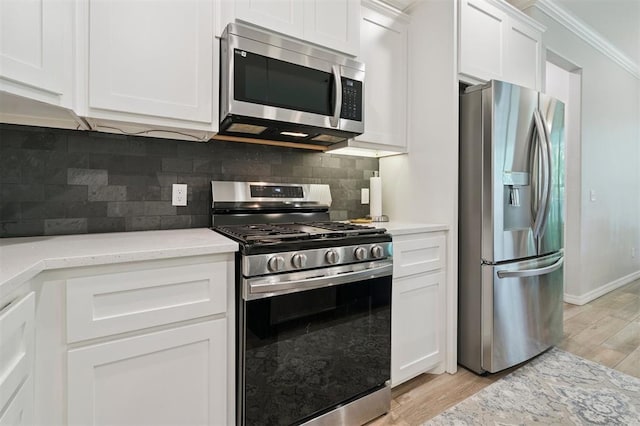 1512 N Kamryn Way, Mustang, OK 73064 - kitchen with appliances with stainless steel finishes, light wood finished floors, crown molding, white cabinetry, and backsplash