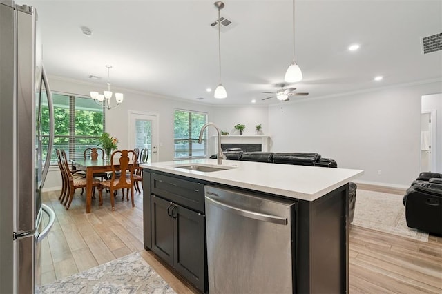 1512 N Kamryn Way, Mustang, OK 73064 - kitchen featuring stainless steel appliances, open floor plan, ornamental molding, light wood finished floors, and light countertops