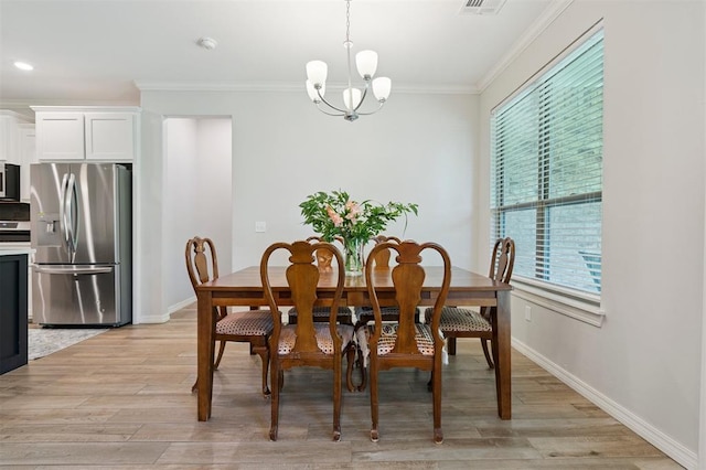 1512 N Kamryn Way, Mustang, OK 73064 - dining room featuring plenty of natural light, a chandelier, crown molding, and light wood-style flooring