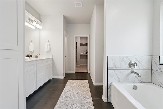 1512 N Kamryn Way, Mustang, OK 73064 - full bathroom featuring vanity, a garden tub, tile patterned flooring, and a spacious closet
