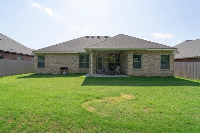 1512 N Kamryn Way, Mustang, OK 73064 - back of house featuring a fenced backyard, a patio area, roof with shingles, and brick siding