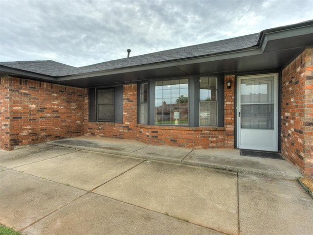 5412 Cloverlawn Dr, Oklahoma City, OK 73135 - property entrance featuring brick siding and roof with shingles