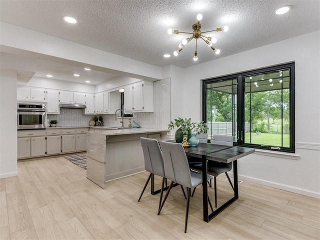 5412 Cloverlawn Dr, Oklahoma City, OK 73135 - dining space with a chandelier, a textured ceiling, light wood finished floors, and recessed lighting