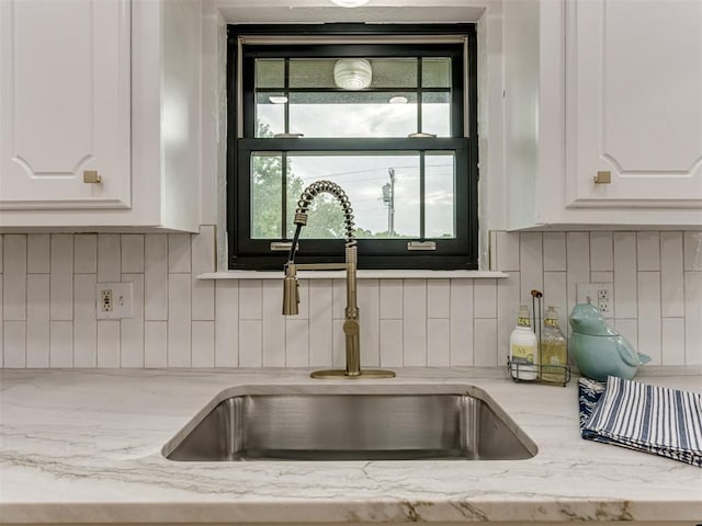 5412 Cloverlawn Dr, Oklahoma City, OK 73135 - kitchen view of white cabinetry, decorative backsplash, and light stone countertops