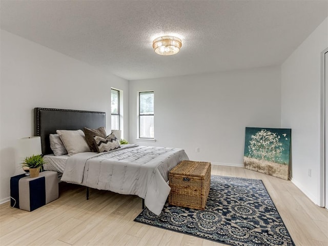5412 Cloverlawn Dr, Oklahoma City, OK 73135 - bedroom with wood finished floors and a textured ceiling