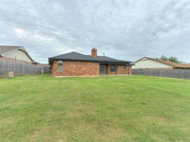 5412 Cloverlawn Dr, Oklahoma City, OK 73135 - back of property featuring brick siding, a fenced backyard, and a chimney
