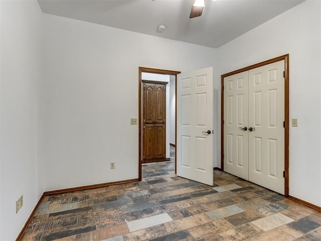 559 Silver Tree Cir, Choctaw, OK 73020 - unfurnished bedroom with a closet, ceiling fan, and stone finish flooring