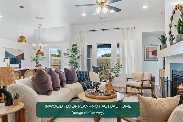 449 Vista Dr, Yukon, OK 73099 - living area with a fireplace, a ceiling fan, wood finished floors, a chandelier, and recessed lighting