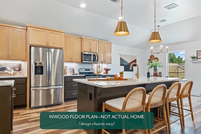 449 Vista Dr, Yukon, OK 73099 - kitchen featuring stainless steel appliances, light brown cabinets, light wood-type flooring, a center island with sink, and lofted ceiling