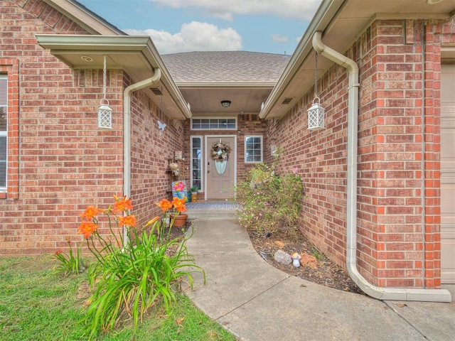1801 Wagon Trail Blvd, Harrah, OK 73045 - entrance to property with brick siding, an attached garage, and roof with shingles