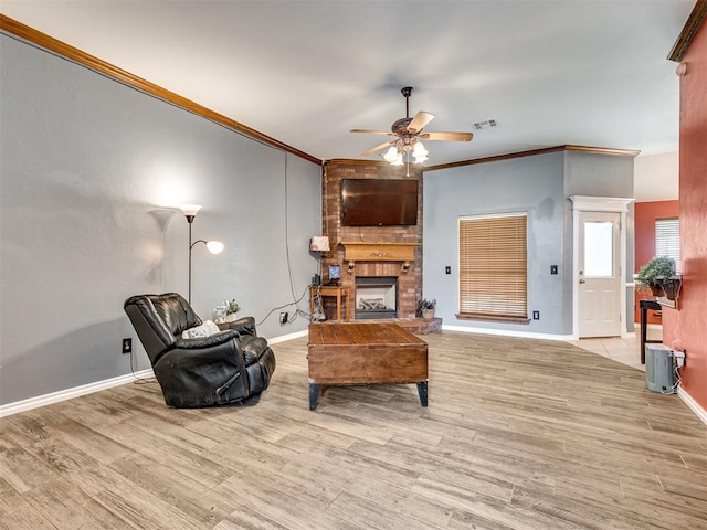 1801 Wagon Trail Blvd, Harrah, OK 73045 - living area with ornamental molding, ceiling fan, a fireplace, and wood finished floors
