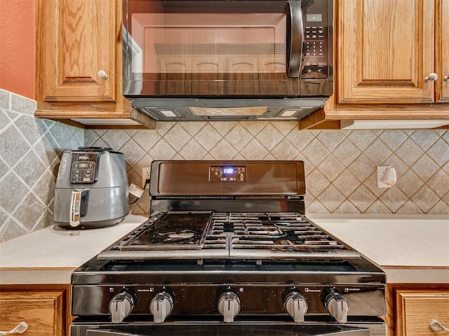 1801 Wagon Trail Blvd, Harrah, OK 73045 - kitchen featuring black appliances, light countertops, and decorative backsplash