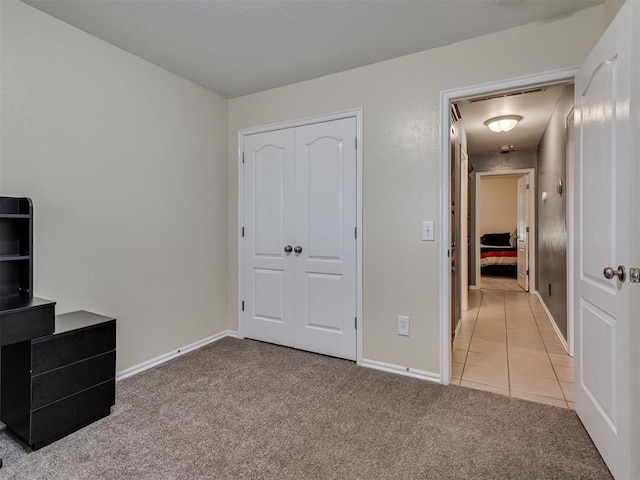 1801 Wagon Trail Blvd, Harrah, OK 73045 - unfurnished bedroom featuring light colored carpet, light tile patterned floors, and a closet