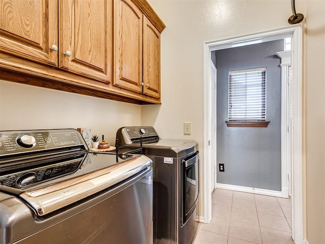 1801 Wagon Trail Blvd, Harrah, OK 73045 - laundry area featuring washing machine and dryer, cabinet space, and light tile patterned floors