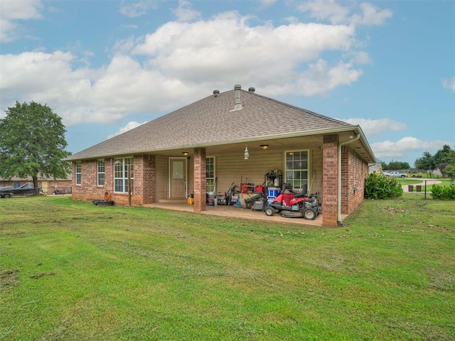 1801 Wagon Trail Blvd, Harrah, OK 73045 - back of property with brick siding, a lawn, a patio area, and a shingled roof