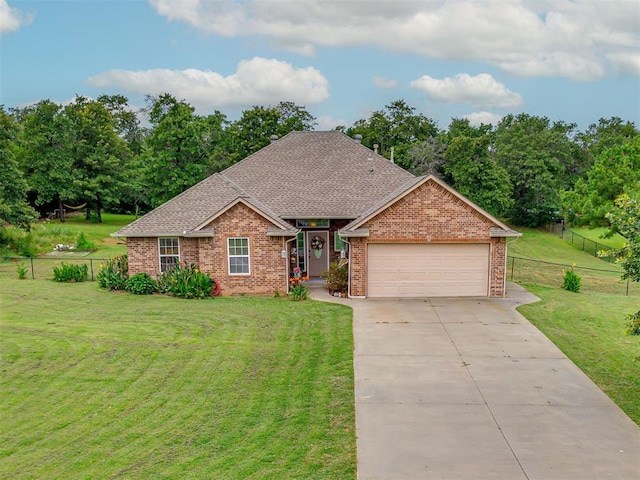 1801 Wagon Trail Blvd, Harrah, OK 73045 - view of front of house featuring a garage, brick siding, driveway, roof with shingles, and view of scattered trees