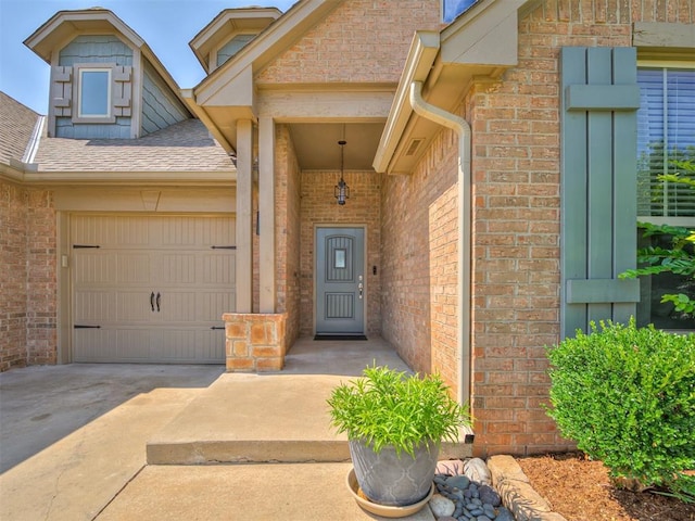10824 NW 32nd Ter, Yukon, OK 73099 - doorway to property featuring brick siding, concrete driveway, an attached garage, and a shingled roof