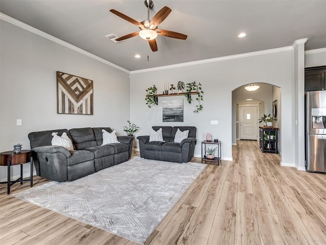 10824 NW 32nd Ter, Yukon, OK 73099 - living area featuring arched walkways, a ceiling fan, light wood finished floors, crown molding, and recessed lighting