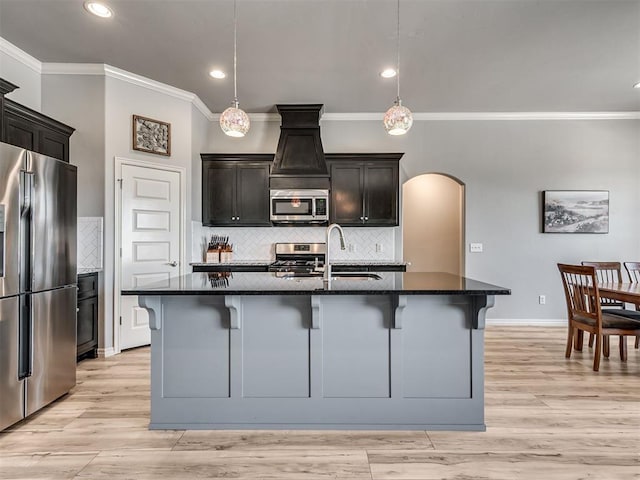 10824 NW 32nd Ter, Yukon, OK 73099 - kitchen with stainless steel appliances, ornamental molding, arched walkways, a breakfast bar, and backsplash