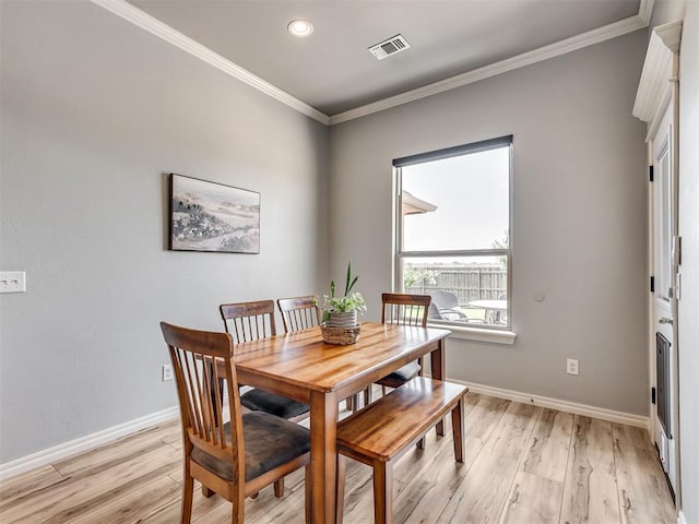 10824 NW 32nd Ter, Yukon, OK 73099 - dining room featuring light wood-style floors, ornamental molding, and recessed lighting
