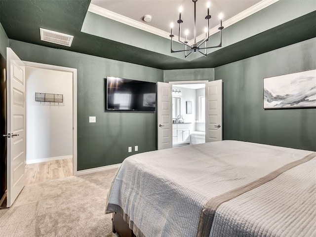 10824 NW 32nd Ter, Yukon, OK 73099 - carpeted bedroom with ornamental molding, a chandelier, and ensuite bath