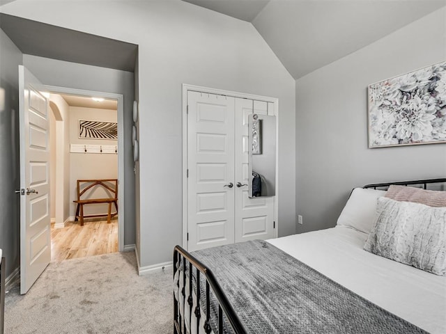 10824 NW 32nd Ter, Yukon, OK 73099 - bedroom featuring lofted ceiling, light carpet, and a closet
