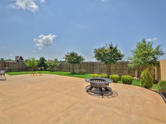 10824 NW 32nd Ter, Yukon, OK 73099 - fenced backyard with an outdoor fire pit and a patio area