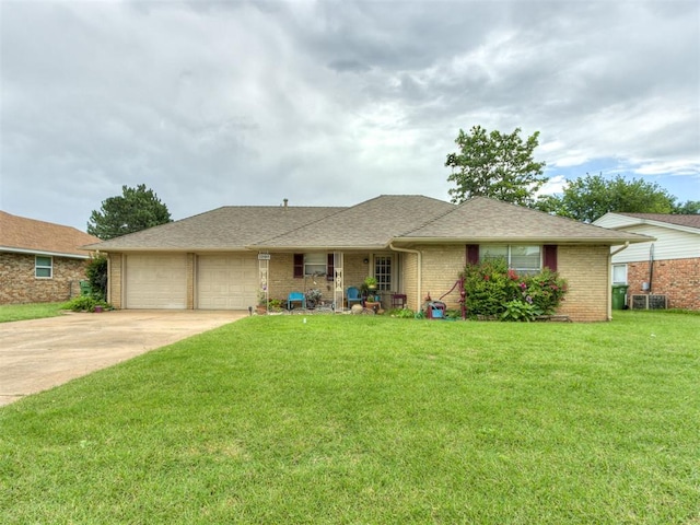 1200 Kingston Dr, Yukon, OK 73099 - single story home with an attached garage, brick siding, a front lawn, concrete driveway, and roof with shingles