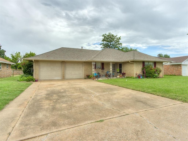 1200 Kingston Dr, Yukon, OK 73099 - ranch-style home featuring a front lawn, a garage, brick siding, and concrete driveway