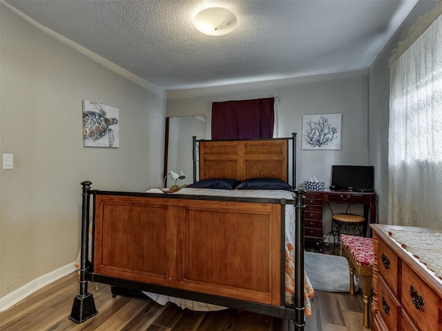 1200 Kingston Dr, Yukon, OK 73099 - bedroom with wood finished floors and a textured ceiling