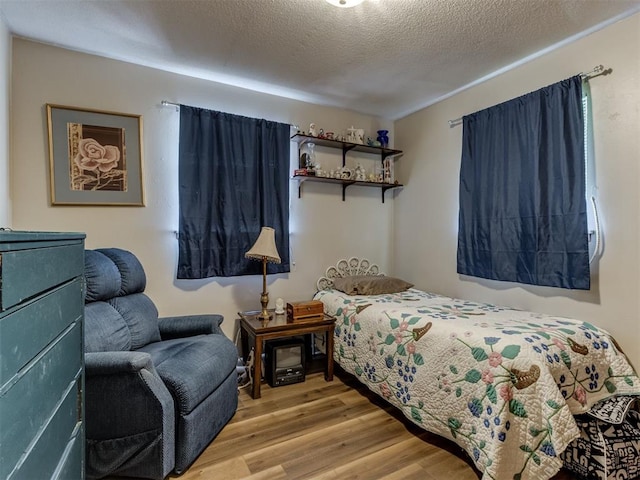 1200 Kingston Dr, Yukon, OK 73099 - bedroom featuring wood finished floors and a textured ceiling