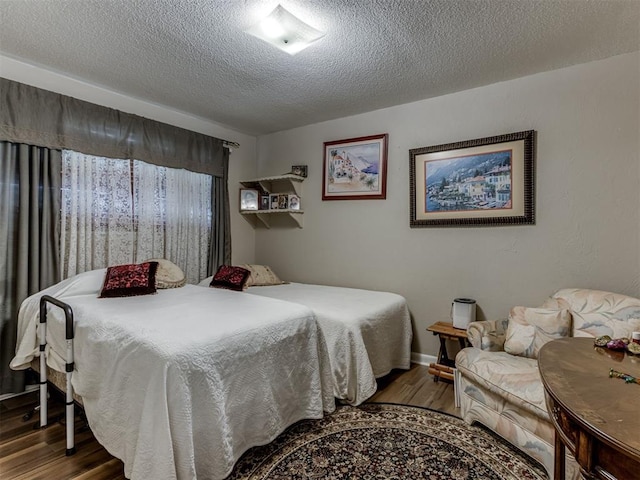 1200 Kingston Dr, Yukon, OK 73099 - bedroom featuring wood finished floors and a textured ceiling