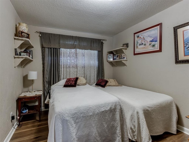 1200 Kingston Dr, Yukon, OK 73099 - bedroom featuring wood finished floors and a textured ceiling