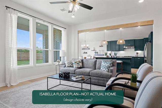 801 Caladium Dr, Yukon, OK 73099 - living room with a ceiling fan, recessed lighting, light wood-style flooring, and a chandelier