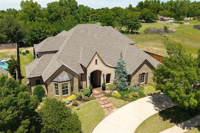 4409 Farm Hill Rd, Norman, OK 73072 - view of front of property with stone siding, a standing seam roof, and a front yard