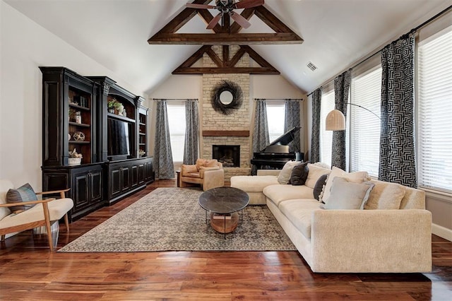 4409 Farm Hill Rd, Norman, OK 73072 - living room featuring plenty of natural light, a fireplace, beam ceiling, a ceiling fan, and dark wood finished floors