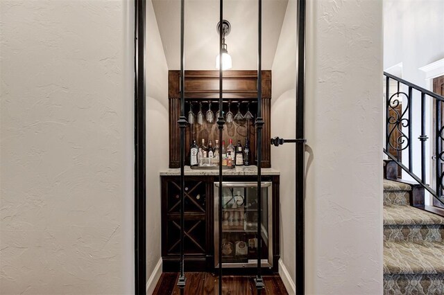 4409 Farm Hill Rd, Norman, OK 73072 - wine room featuring a textured wall and wood finished floors