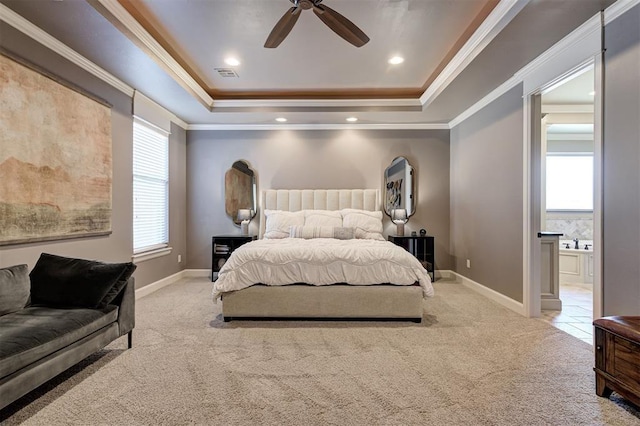 4409 Farm Hill Rd, Norman, OK 73072 - carpeted bedroom featuring a tray ceiling, multiple windows, ornamental molding, ensuite bath, and a ceiling fan