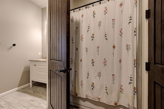 4409 Farm Hill Rd, Norman, OK 73072 - bathroom with wood finished floors, vanity, and shower / bath combination with curtain