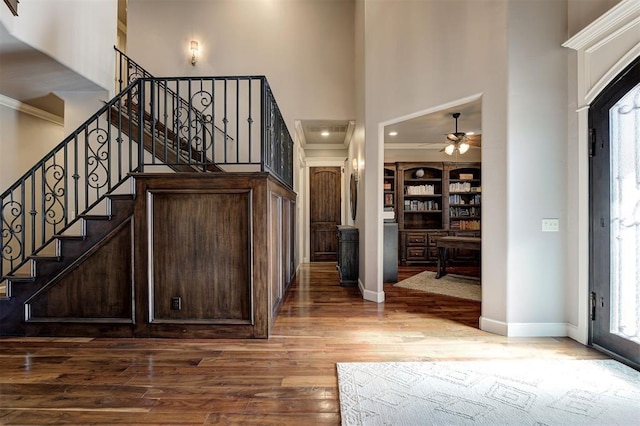 4409 Farm Hill Rd, Norman, OK 73072 - entryway featuring wood finished floors, a towering ceiling, a ceiling fan, healthy amount of natural light, and ornamental molding